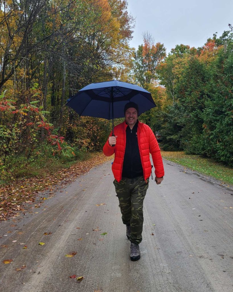 Mike walking a fall road in Ontario